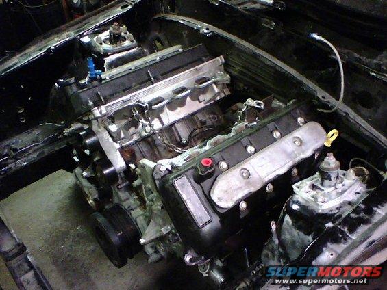 Engine installed in car bay, appears to be a V8