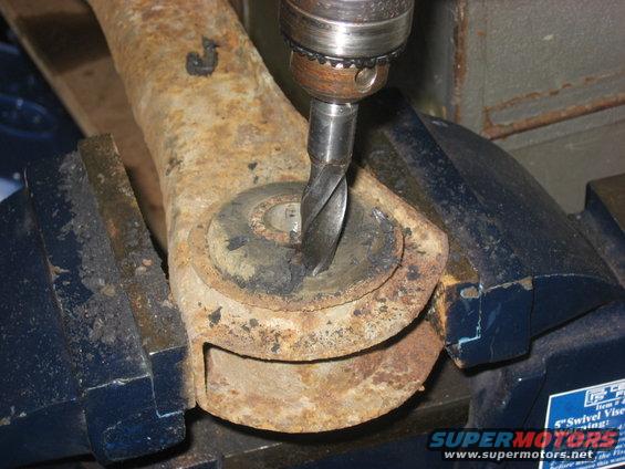 img_0445.jpg Drill holes in the old rubber bushing. Once several holes are drilled next to eachother, the inner steel sleave will come out easily and the rest of the rubber bushing will come out. 