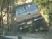 1989 Ford Bronco - This vehicle is navigating a wooded trail, with its rear end visible as it drives along the path.