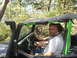 1989 Ford Bronco - A man smiles from the driver's seat of a Jeep Wrangler equipped with a snorkel, suggesting off-road use.