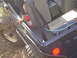 1989 Ford Bronco - A fire extinguisher is mounted inside a modified Jeep, with visible hoses and a storage box in the rear.
