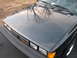 1987 Volkswagen Scirocco - Front view of a 1987 Volkswagen Scirocco, showing the hood and grille with tree reflections.