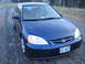 2001 Honda Civic - Front 3/4 view of a blue 2001 Honda Civic coupe parked on a gravel road.