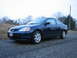 2001 Honda Civic - Dark blue 2001 Honda Civic coupe parked on a paved surface with trees in the background.