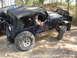1989 Ford Bronco - Modified Jeep Wrangler tackling rough terrain with another vehicle in the background.