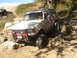 1989 Ford Bronco - This 1989 Ford Bronco is shown tackling a challenging rocky trail, equipped with a Hi-Lift jack on its front bumper.