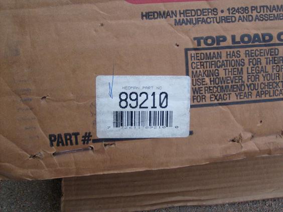 Cardboard box with Hedman Part No. 89210 label and text about certifications