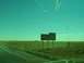 1995 Ford C-350 (Centurion Conversions) - A sign points the way to Meteor Crater, a natural landmark, off the highway.
