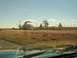 1995 Ford C-350 (Centurion Conversions) - A collection of vehicles are parked in front of a large dome-shaped building in a desert environment.