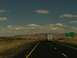 1995 Ford C-350 (Centurion Conversions) - A semi-trailer truck travels down a highway with a sign for Hawthorne Rd. visible.