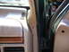 1995 Ford C-350 (Centurion Conversions) - Close-up of the interior A-pillar and dashboard trim, with a vent and wood accent visible.