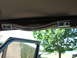 1995 Ford C-350 (Centurion Conversions) - Interior view of a vehicle's headliner trim, showing chrome accents and light switch controls.