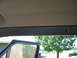 1995 Ford C-350 (Centurion Conversions) - View from inside a vehicle, showing the door frame and headliner with a glimpse of the outdoors and other vehicles.