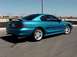 1994 Ford Mustang - This teal 1994 Ford Mustang coupe features a distinctive rear spoiler and a 3/4 front view.