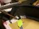 1995 Ford C-350 (Centurion Conversions) - Fiberglass repair in progress on a vehicle part, with tape and tools visible.
