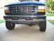 1995 Ford C-350 (Centurion Conversions) - Front view of a teal Ford truck, showing the grille, headlights, and bumper.