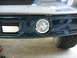1995 Ford C-350 (Centurion Conversions) - Close-up of a vehicle's front valance, showing a fog light and vent detail.