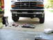 1995 Ford C-350 (Centurion Conversions) - Frontal view of a 1995 Ford C-350 (Centurion Conversions) truck, with tools laid out on the concrete.