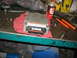 1995 Ford C-350 (Centurion Conversions) - A close-up view of an engine control module resting on a red cloth on a cluttered workbench.