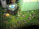 1995 Ford C-350 (Centurion Conversions) - Close-up of a green circuit board a triangular capacitor and multiple integrated circuits.