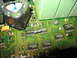 1995 Ford C-350 (Centurion Conversions) - Close-up of a green circuit board with various electronic components including integrated circuits, a resistor, and a large capacitor.