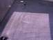 1995 Ford C-350 (Centurion Conversions) - The interior carpet of a vehicle is visible, with a shadow falling across it.