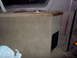 1995 Ford C-350 (Centurion Conversions) - Custom interior console with cup holders and wood trim, covered in tan carpet.