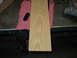 1995 Ford C-350 (Centurion Conversions) - A wooden part, possibly for an overhead console, rests on a pink cloth on a workbench.