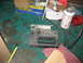 1995 Ford C-350 (Centurion Conversions) - Workshop scene with a jigsaw, tape measure, and various automotive parts and supplies.