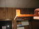 1995 Ford C-350 (Centurion Conversions) - Wooden part, possibly a bracket, held up for inspection.