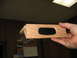 1995 Ford C-350 (Centurion Conversions) - A wooden part, possibly for an overhead console, is held up for inspection.