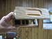 1995 Ford C-350 (Centurion Conversions) - A wooden overhead console with several black switches is held by a hand.