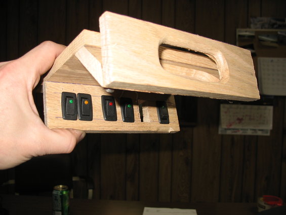 Wooden overhead console with six toggle switches, two with indicator lights