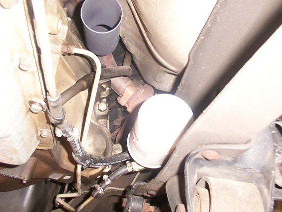 Transmission filter and exhaust pipe under a vehicle