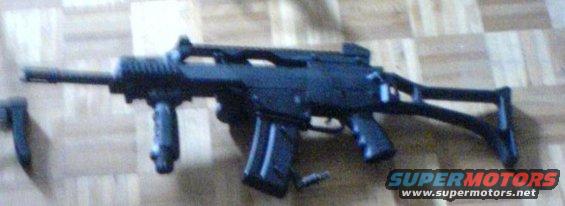 Assault rifle with folding stock on a wood-grain surface