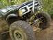 1989 Ford Bronco - This heavily modified off-road vehicle is covered in mud, suggesting it has been used for extreme terrain.