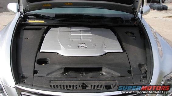 Silver Lexus with hood open showing V8 engine cover. The engine cover has a Lexus logo