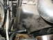 1995 Ford C-350 (Centurion Conversions) - Close-up view of the AC condenser housing and associated hoses, with a wrench engaged on a bolt.