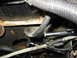 1995 Ford C-350 (Centurion Conversions) - Engine bay detail with hoses, wiring, and a tool in use.