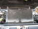 1995 Ford C-350 (Centurion Conversions) - The AC condenser is visible under the hood, showing signs of wear and dirt accumulation.