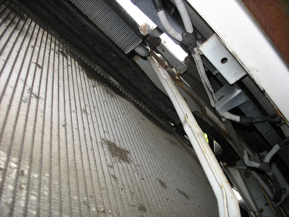 AC condenser and radiator with white hose and wiring