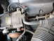 1995 Ford C-350 (Centurion Conversions) - Close-up view of the AC compressor and associated hoses within an engine compartment.