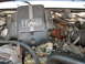1995 Ford C-350 (Centurion Conversions) - Close-up of an engine bay, showing the turbo diesel direct injection cover and various engine parts.