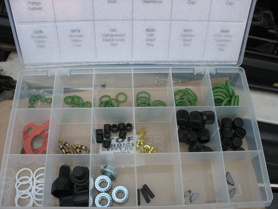 Organizer box with compartments filled with O-rings, seals, and other small automotive parts