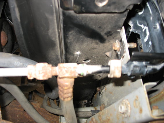 AC condenser lines with rust and a 1/2" hose visible