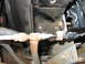1995 Ford C-350 (Centurion Conversions) - Close-up view of AC condenser lines and hoses, showing signs of rust and wear.
