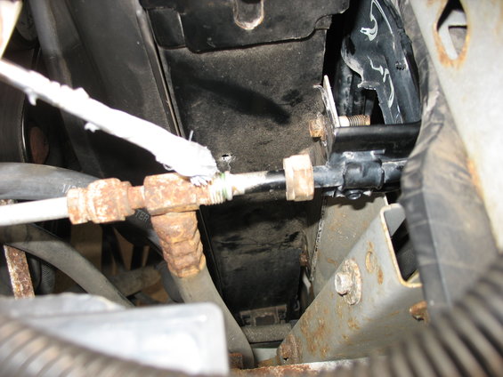 Close-up of rusted AC lines and a black mounting bracket with bolts