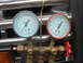 1995 Ford C-350 (Centurion Conversions) - AC manifold gauge set with blue and red gauges mounted in front of a chrome grille.