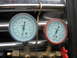 1995 Ford C-350 (Centurion Conversions) - AC manifold gauge set with two gauges, one blue and one red, displaying pressure readings for R134a refrigerant.
