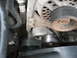 1995 Ford C-350 (Centurion Conversions) - Engine belt tensioner and pulley system detail. Wear is visible on the pulley's edge.
